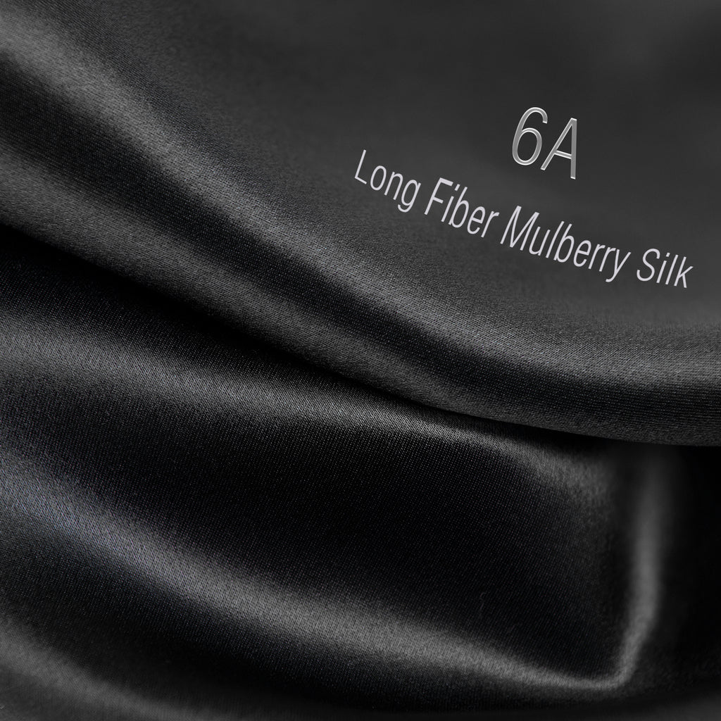 Black 6A long fiber mulberry silk fabric close-up with smooth, shiny texture
