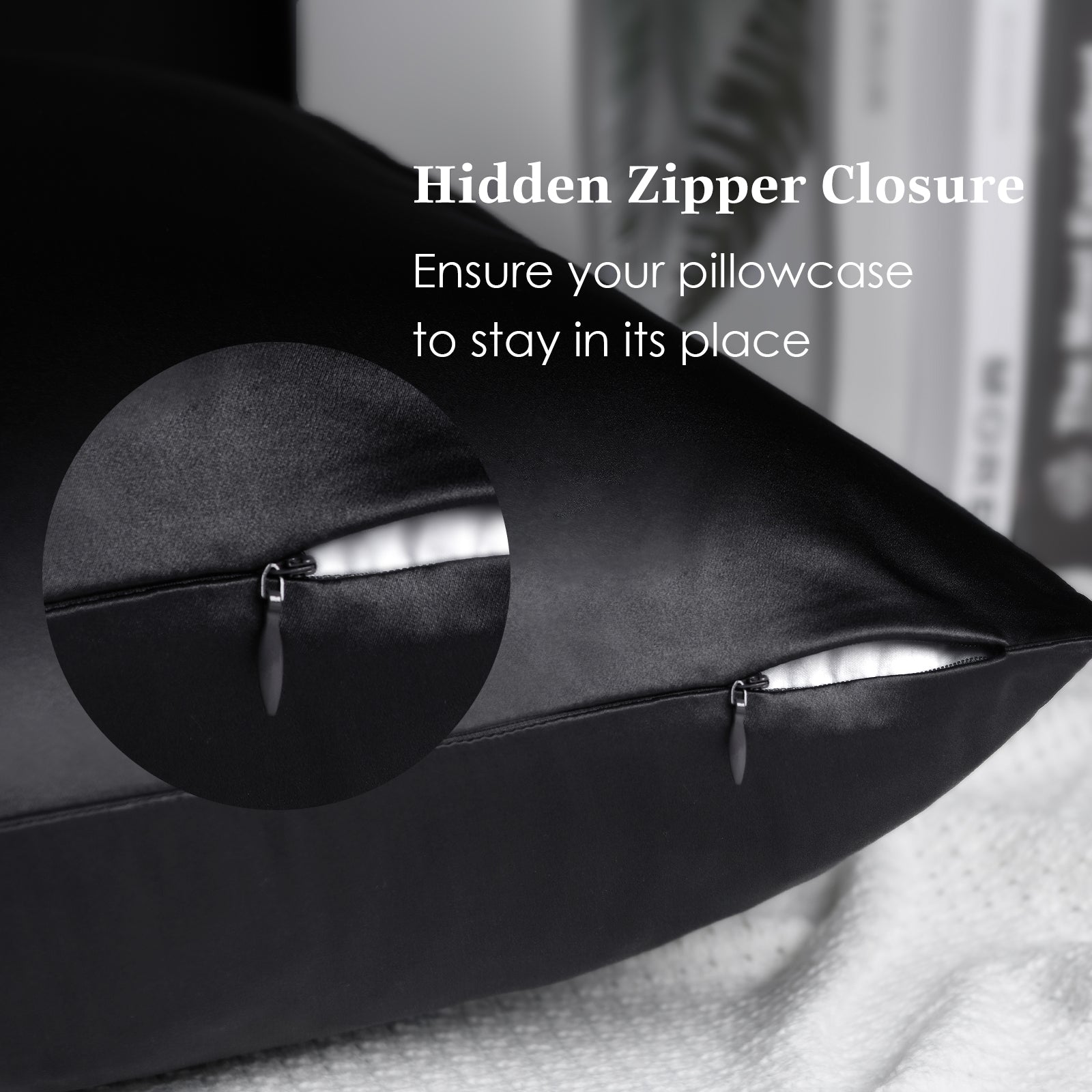 Black silk pillowcase with hidden zipper closure on a bed, close-up detail shown.
