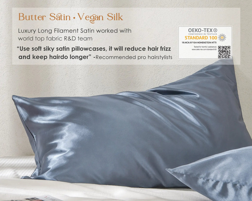 Butter satin vegan silk blue pillowcases on a bed with OEKO-TEX certification label visible.