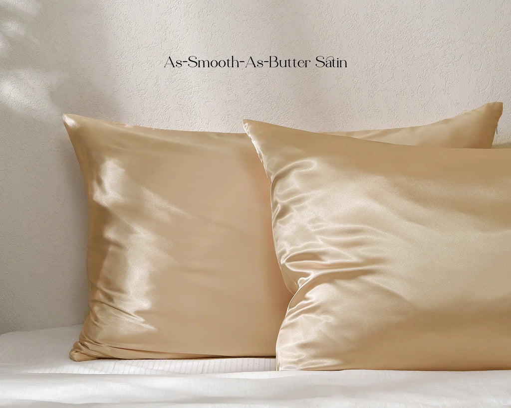 Golden champagne satin pillowcases set on a bed with smooth, shiny finish