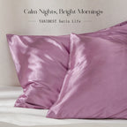 Pair of marve purple satin pillowcases on a bed with a soft fabric sheen