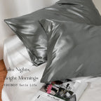 Modern gray satin pillowcases set on a white bed, glossy finish, bedroom decor
