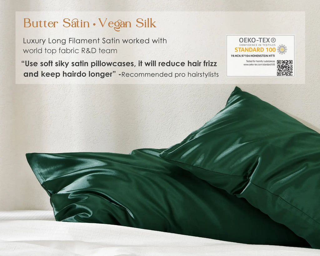 Olive green satin pillowcases set of two displayed on a white bed against a neutral wall.