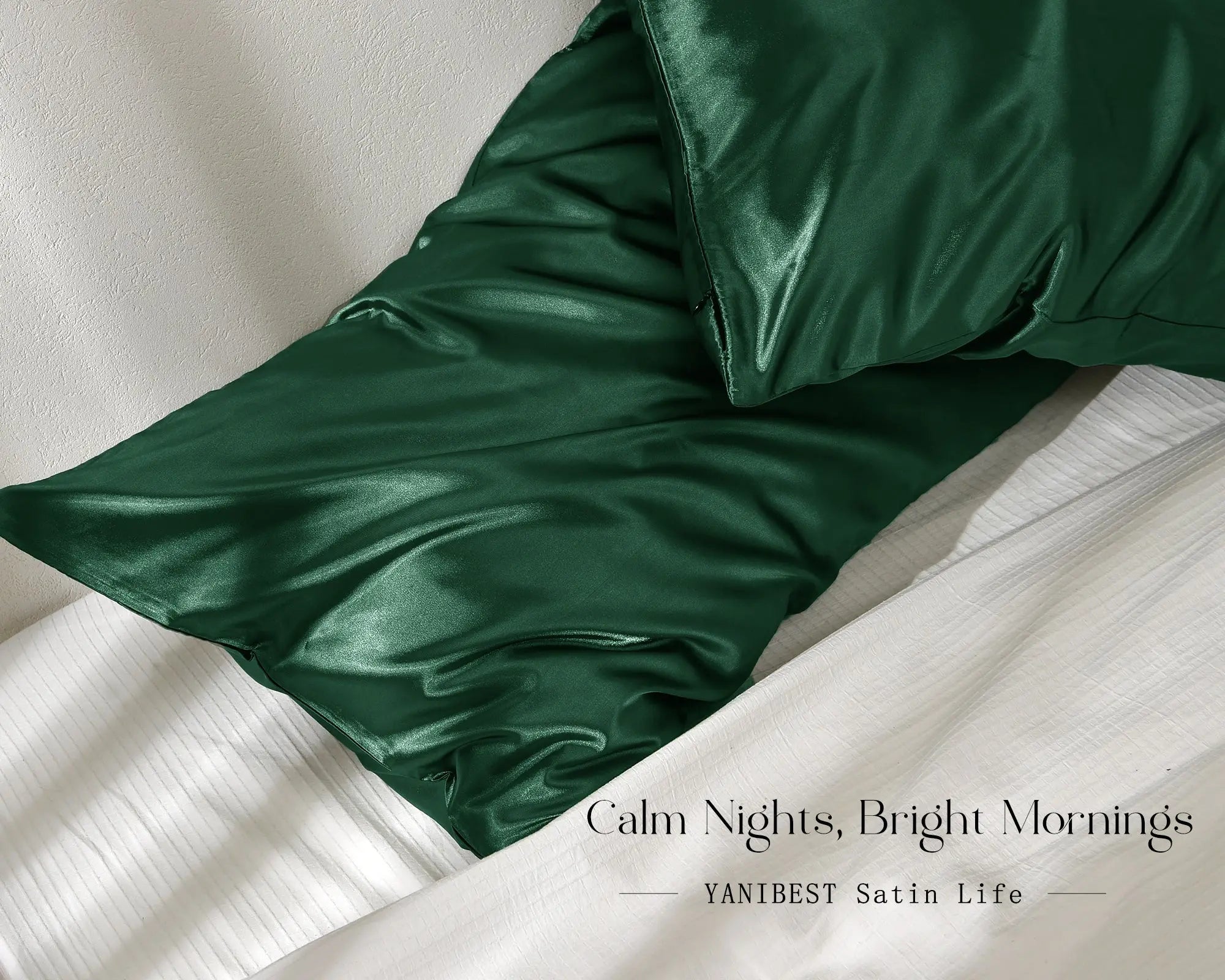 Olive green satin pillowcases set on a white bed, smooth and shiny texture