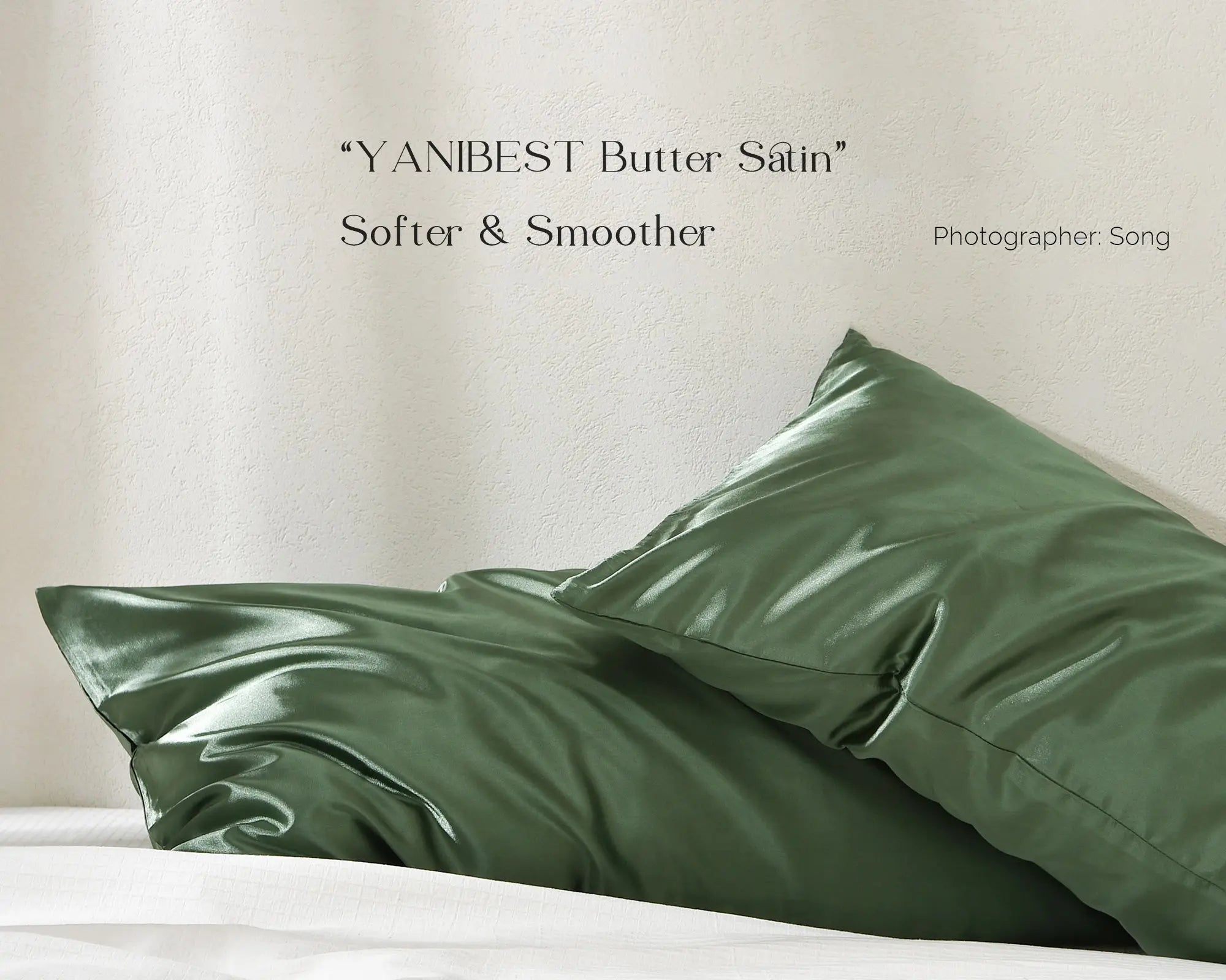 Sage green satin pillowcases on bed, shiny smooth finish, 2-pack set