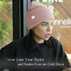 Woman wearing a rose pink satin-lined cuffed beanie hat indoors, showcasing winter fashion.