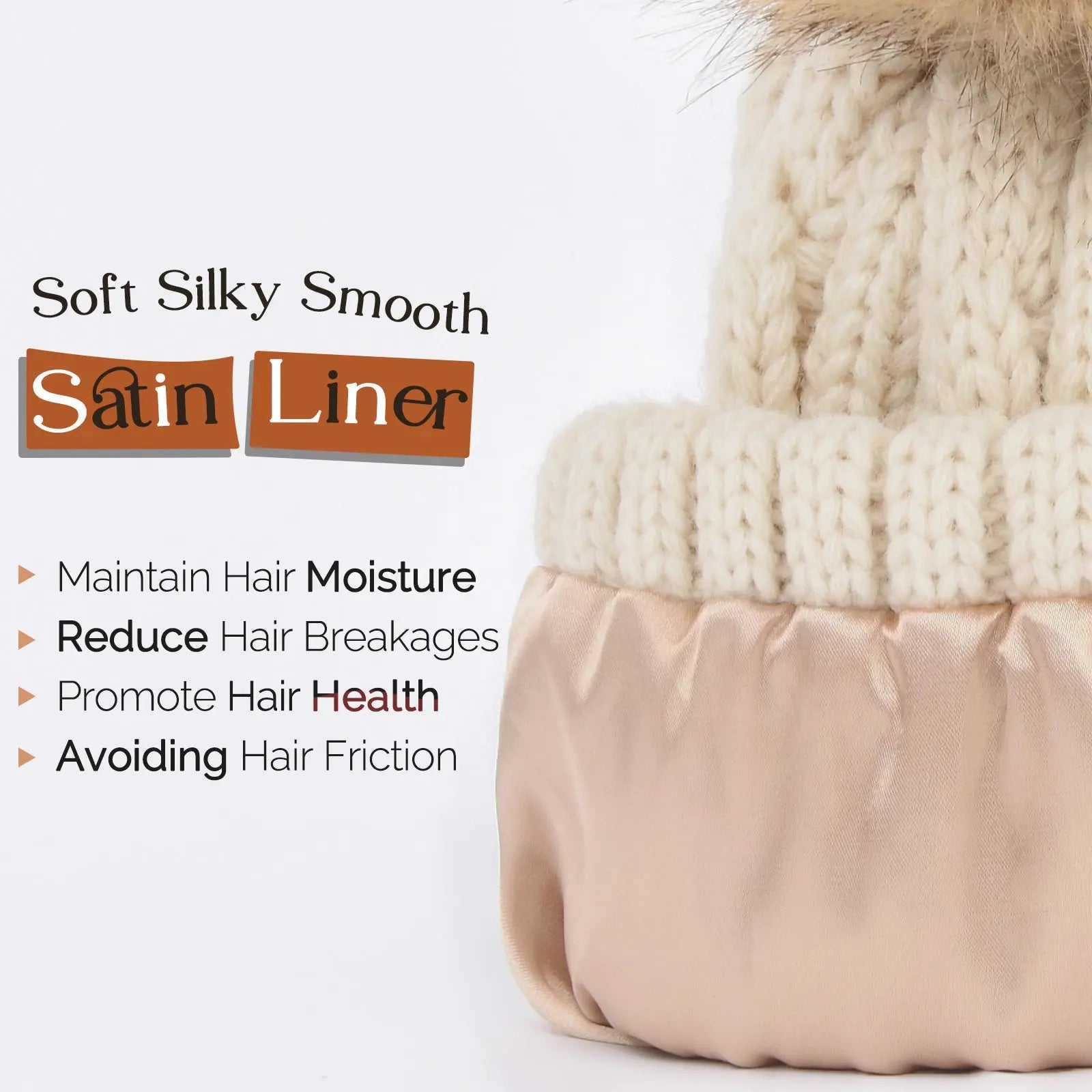 Cream knit winter beanie with beige satin lining and faux fur pompom, text highlighting satin liner benefits.