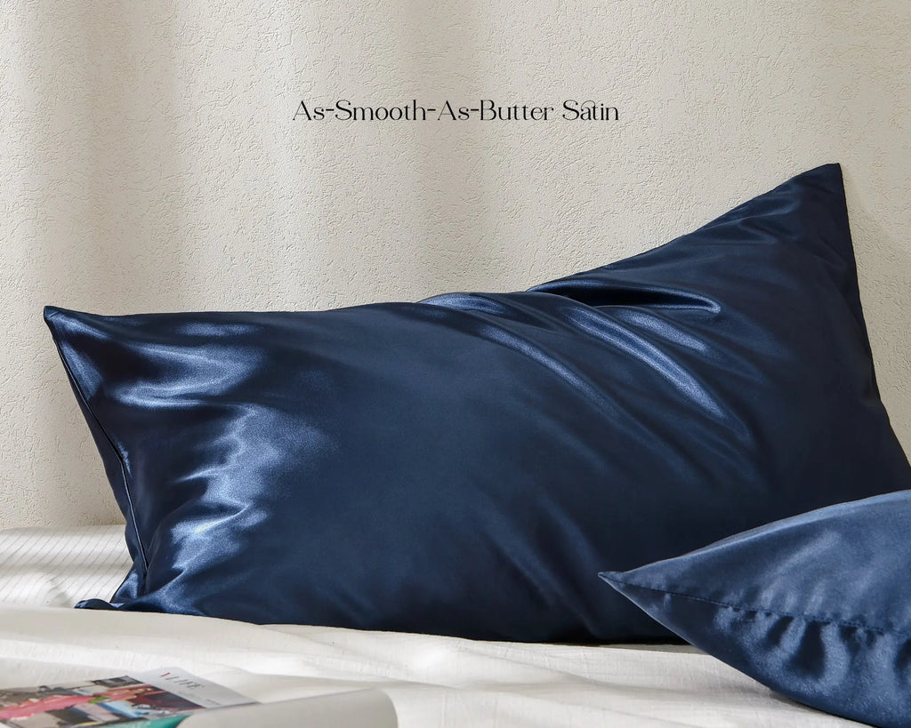 Ocean blue satin pillowcases with smooth shiny finish on a white bed